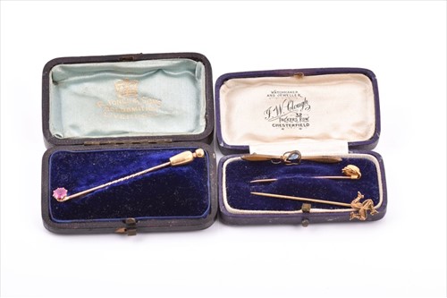 Lot 529 - A gold and ruby stick pin set with an oval-cut...