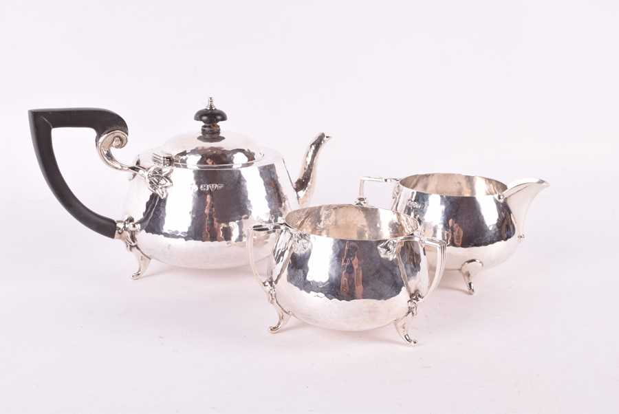 Lot 437 - A Edwardian Arts & Crafts style silver tea set...
