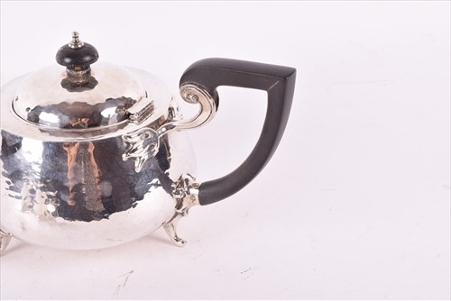Lot 437 - A Edwardian Arts & Crafts style silver tea set...