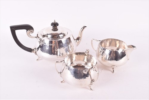 Lot 437 - A Edwardian Arts & Crafts style silver tea set...