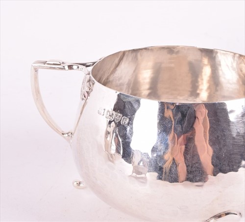 Lot 437 - A Edwardian Arts & Crafts style silver tea set...