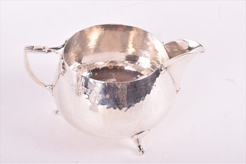 Lot 437 - A Edwardian Arts & Crafts style silver tea set...