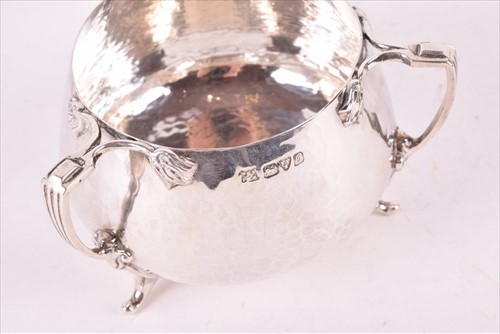 Lot 437 - A Edwardian Arts & Crafts style silver tea set...