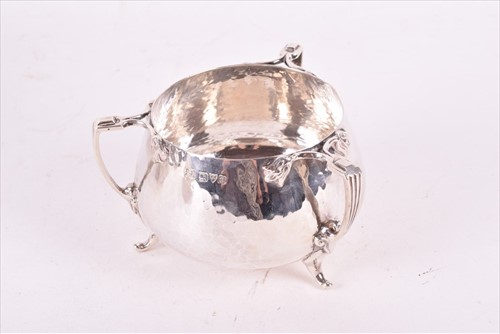 Lot 437 - A Edwardian Arts & Crafts style silver tea set...