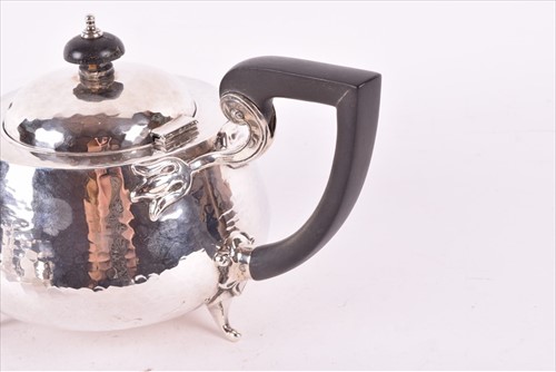 Lot 437 - A Edwardian Arts & Crafts style silver tea set...