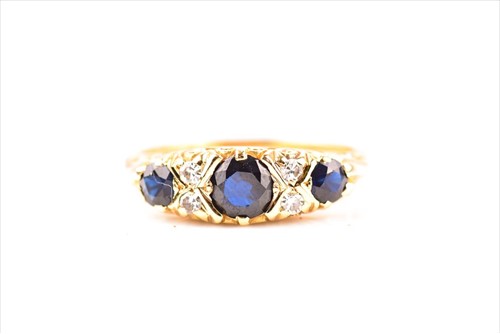 Lot 450 - An 18ct yellow gold, diamond, and sapphire...