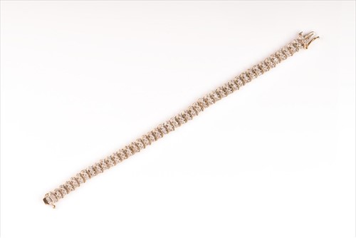 Lot 443 - A 9ct yellow gold and diamond bracelet set...