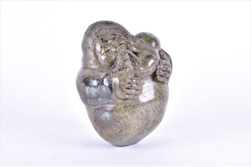 Lot 207 - A hardstone Inuit carving of a mother and...