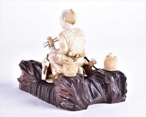 Lot 138 - A Japanese Meiji period carved ivory okimono...