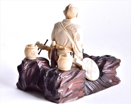 Lot 138 - A Japanese Meiji period carved ivory okimono...