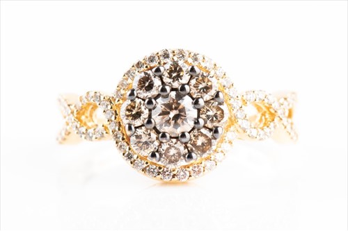 Lot 559 - A white and cognac diamond floral ring set...