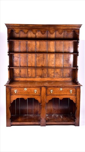 Lot 8 - A large 18th century style oak dresser the top...