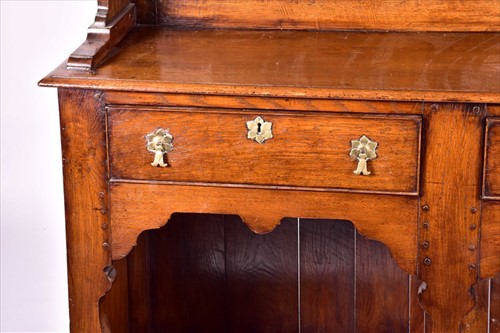 Lot 8 - A large 18th century style oak dresser the top...