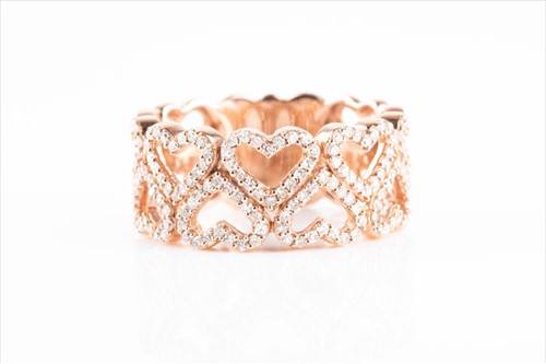 Lot 562 - A 9ct rose gold and diamond heart design ring...