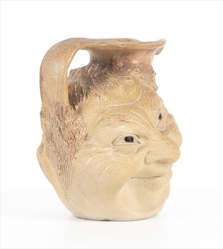 Lot 202 - A Martin Brothers double-sided stoneware face...
