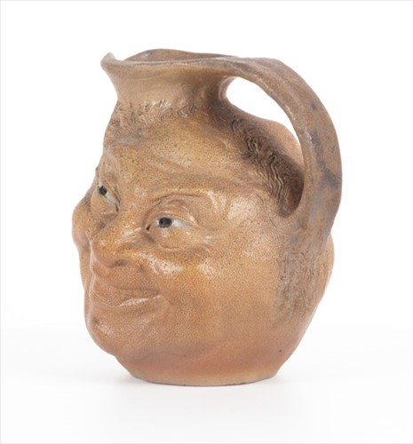 Lot 203 - A Martin Brothers double-sided stoneware face...