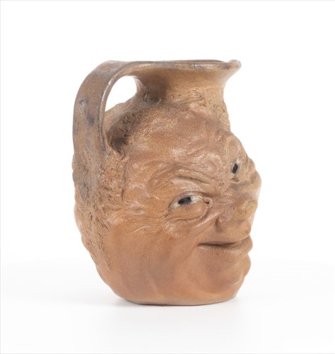 Lot 223 - A Martin Brothers double-sided stoneware face...