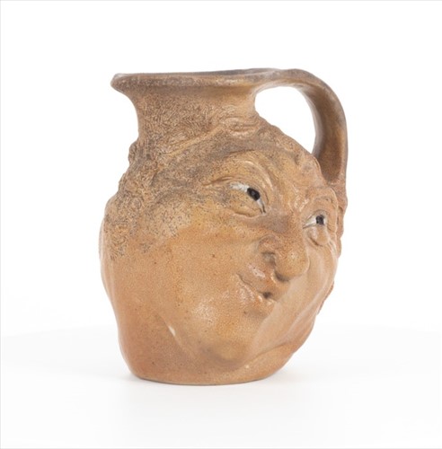 Lot 223 - A Martin Brothers double-sided stoneware face...