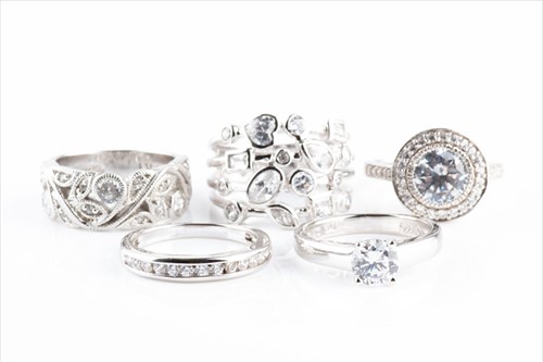 Lot 624 - A group of five various silver and CZ rings...