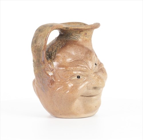 Lot 205 - A Martin Brothers double-sided stoneware face...
