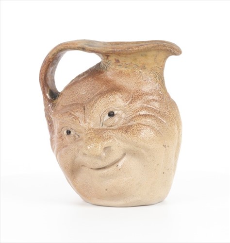 Lot 205 - A Martin Brothers double-sided stoneware face...