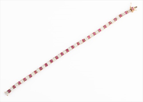 Lot 547 - A 9ct yellow gold, diamond, and ruby line...