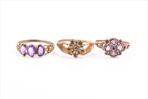 Lot 573 - A yellow metal and peridot ring in the form of...