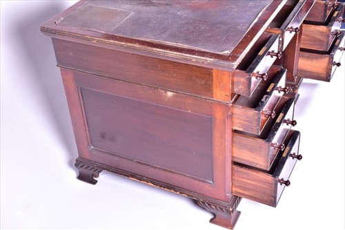 Lot 15 - An Edwardian mahogany nine drawer pedestal...