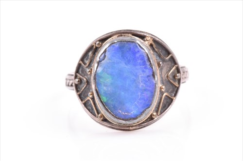 Lot 568 - A silver and opal ring in the Arts and Crafts...
