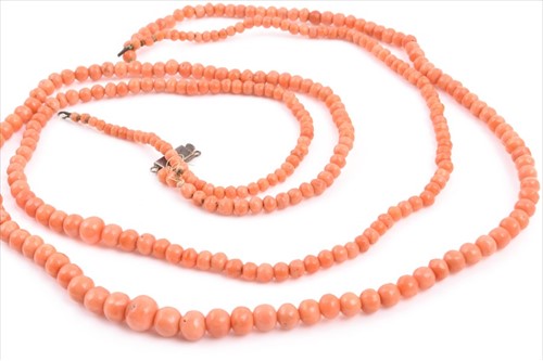 Lot 562 - Two coral bead necklaces one larger, both...