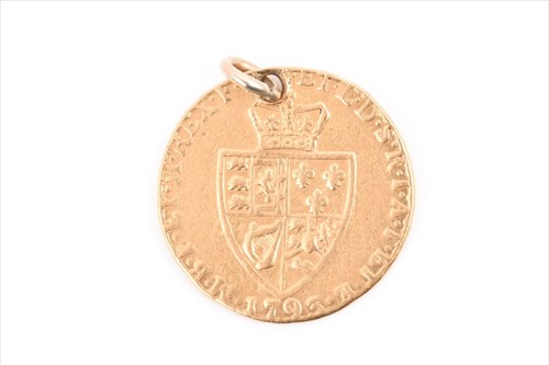 Lot 556 - A George III spade guinea pendant drilled,...