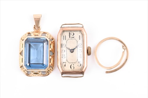Lot 557 - A yellow metal and blue topaz pendant set with...