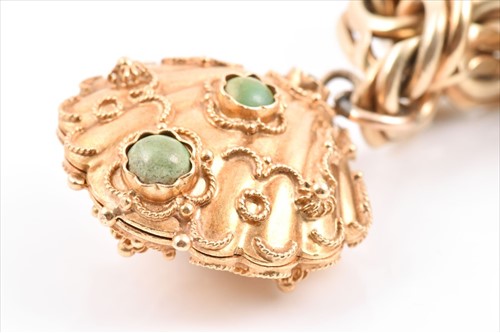 Lot 657 - An unusual yellow metal charm bracelet of...