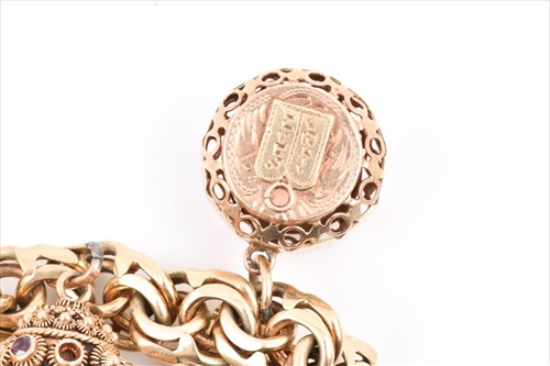 Lot 657 - An unusual yellow metal charm bracelet of...