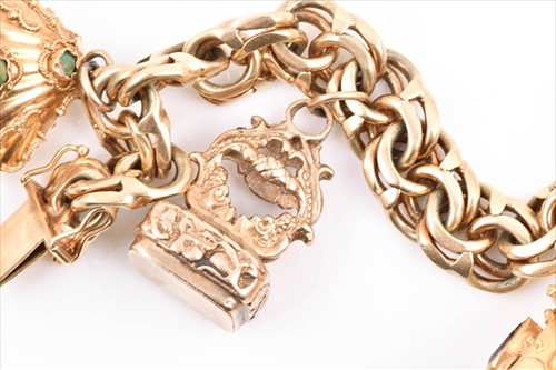 Lot 657 - An unusual yellow metal charm bracelet of...
