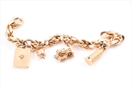 Lot 614 - An unusual yellow metal charm bracelet...