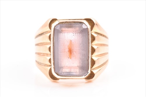 Lot 617 - A yellow metal and amethyst ring inset with a...