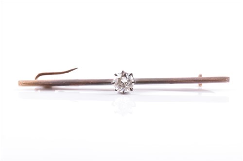 Lot 513 - A 15ct yellow metal and solitaire diamond bar...