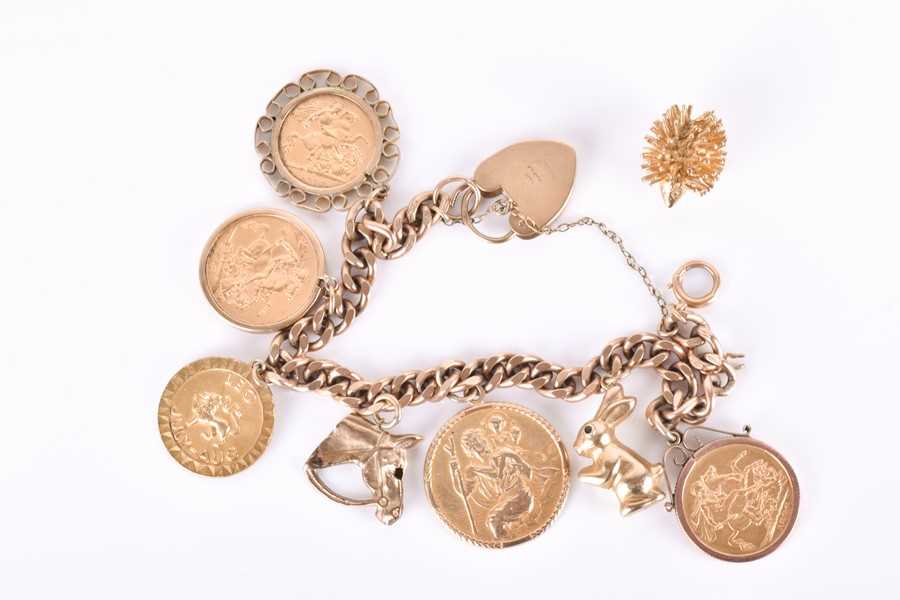 A 9ct yellow gold curb-link bracelet suspended with two full sovereigns, a...