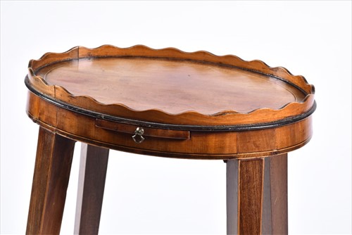 Lot 61 - A small George III oval wine table with wave...