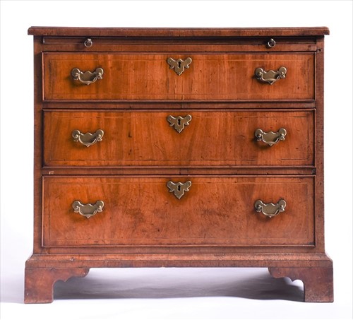 Lot 152 - A small Georgian straight fronted walnut chest...
