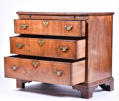 Lot 152 - A small Georgian straight fronted walnut chest...
