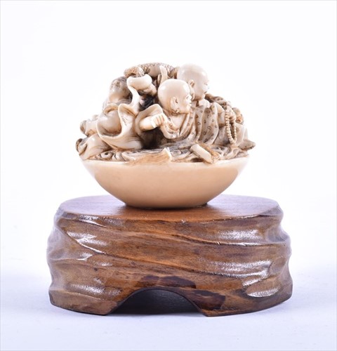 Lot 252 - A Japanese Meiji period carved ivory netsuke...