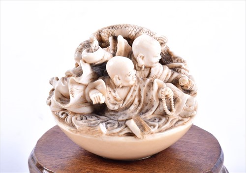 Lot 252 - A Japanese Meiji period carved ivory netsuke...