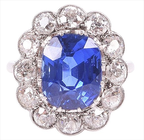 Lot 1 - A sapphire and diamond cluster ring set with a...