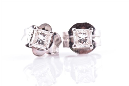 Lot 635 - A pair of 18ct white gold and diamond ear...