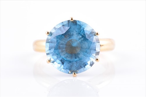 Lot 648 - A yellow metal and blue topaz cocktail ring...