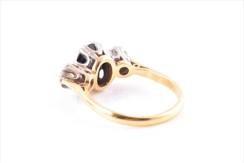 Lot 561 - A diamond and sapphire three stone ring...