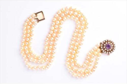 Lot 512 - A three row cultured pearl necklace the...