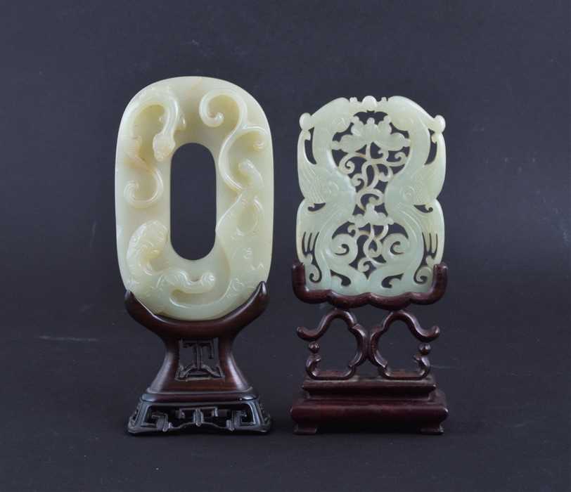 Lot 116 - A Chinese carved celadon jade plaque on a...